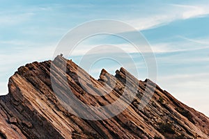 Hiker climbing on rock formations at Vasquez Rocks Natural Area Park