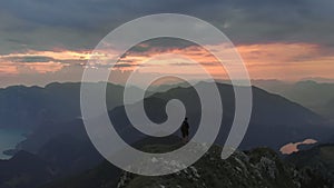 Hiker climbing Schafberg mountain at sunrise in Austria