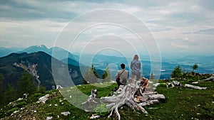 Petzen - Hiker couple on alpine meadow near Feistritzer Spitze (Hochpetzen) with panoramic view of majestic mountain peaks photo