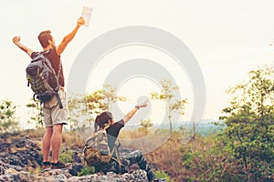 Hiker couple backpack enjoy happy and sitting happy feeling freedom good and strong weight victorious facing on the natural mounta
