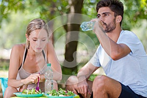 Hiker couple enjoying luch outdoors