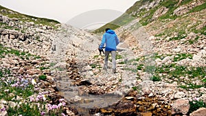 Hiker couple father and son in beautiful landscape. Hikers man and child trekking walking with backpacks in trail in mountains