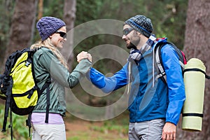 Hiker couple holding hands in forest