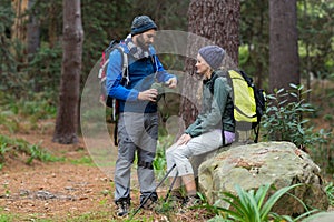 Hiker couple interacting with each other in forest