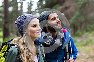 Hiker couple looking at nature in forest