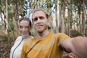 Hiker couple taking selfie in the forest