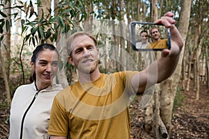 Hiker couple taking selfie in the forest