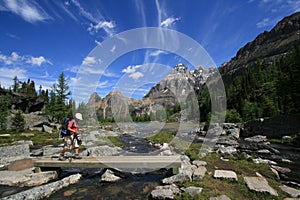 Hiker Crossing Creek in Yoho National Park