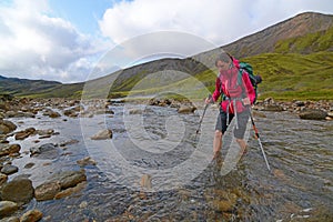 Hiker crossing river