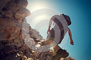 Hiker crossing rocky terrain