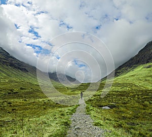 Hiker on in the dramatic valley of Buachaille Etive Beag in the Scottish Highlands
