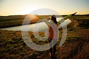 hiker enjoy the sunset view on riverside hill top