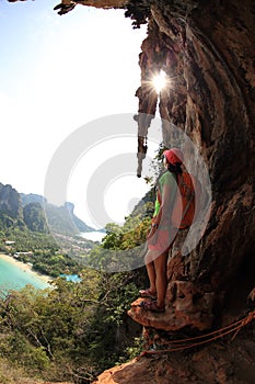 Hiker enjoy the view at sunrise mountain peak cliff