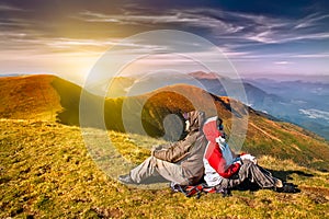 Hiker enjoying valley view from top of a mountain