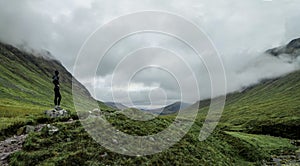 Hiker enjoying view of Buachaille Etive Beag landscape in the Scottish Highlands