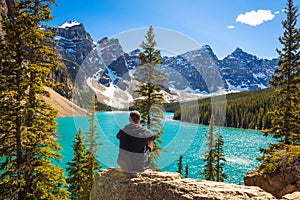 Hiker enjoying the view of Moraine lake in Banff National Park