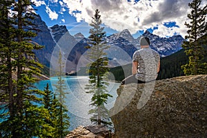 Hiker enjoying the view of Moraine lake in Banff National Park