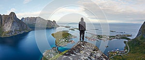 Hiker enjoying the view over Reinefjorden, Lofoten, Norway