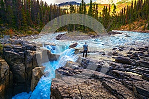 Hiker at the f Upper Sunwapta Falls in Jasper National Park, Canada