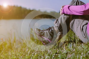 Hiker female sitting at nature,Hiking shoes woman in beautiful view,Close up