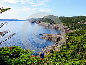 A hiker fist pumping while hiking the east coast trail off the coast of Newfoundland and Labrador, Canada.