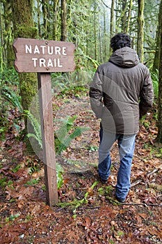 Hiker following a sign