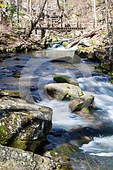 Hiker Footbridge over a Cascading Mountain Stream