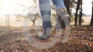 hiker free girl feet walk in the park forest. travel concept. close-up of a leg free girl walking in the park in the
