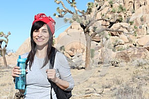 Hiker in front of Joshua Trees in Joshua Tree National Park, California