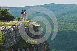 Hiker girl with a child in a backpack