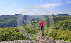 Hiker girl enjoying the scenery on the top of Mont-du-Lac-des-Cygnes in Grand Jardins National Park photo