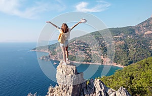 Hiker girl on the mountain top, concept of freedom, victory, active lifestyle, Kabak beach, Oludeniz, Turkey