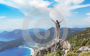 Hiker girl on the mountain top, Ñoncept of freedom, victory, active lifestyle, Oludeniz, Turkey