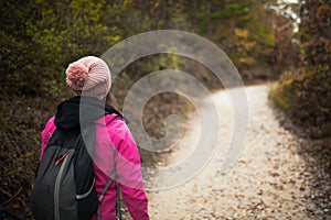 Hiker girl walking on a path in the mountains.