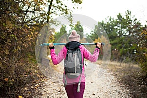 Hiker girl walking on a path in the mountains.