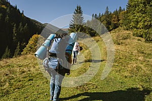 Hiker goes to the mountains on a sunset hike. Ecotourism photo