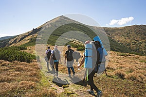 Hiker goes to the mountains on a sunset hike. Ecotourism photo