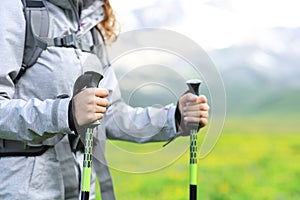 Hiker hands using poles in the mountain