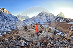 Hiker happy woman trekking on the snow in a snowy mountain