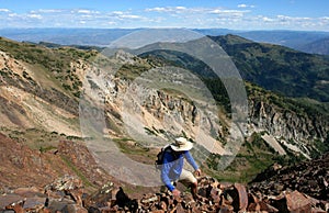 Hiker high on mountain ridge