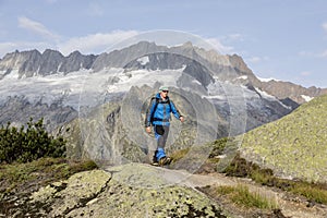 Hiker hikes through a breathtaking alpine landscape in the mountains