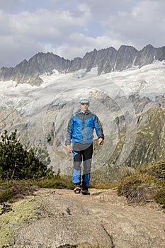 Hiker hikes through a breathtaking alpine landscape in the mountains
