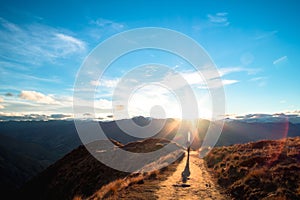 A hiker hiking on the beautiful track with a landscape of the mountains and Lake Wanaka. Roys Peak Track, South Island, New