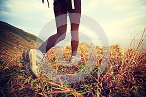 Hiker hiking on seaside mountain peak