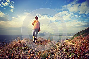 Hiker hiking on seaside mountain peak