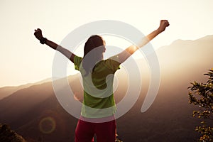 Hiker hiking on summer sunrise mountain