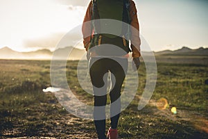 Hiker hiking on sunset mountains