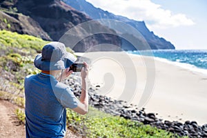 Hiker at Kalalau Beach in the Na Pali Coast of Kauai, Hawaii