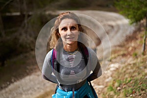 Hiker lady with backpack alone on the trail