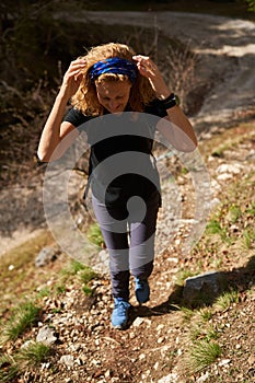 Hiker lady with backpack alone on the trail